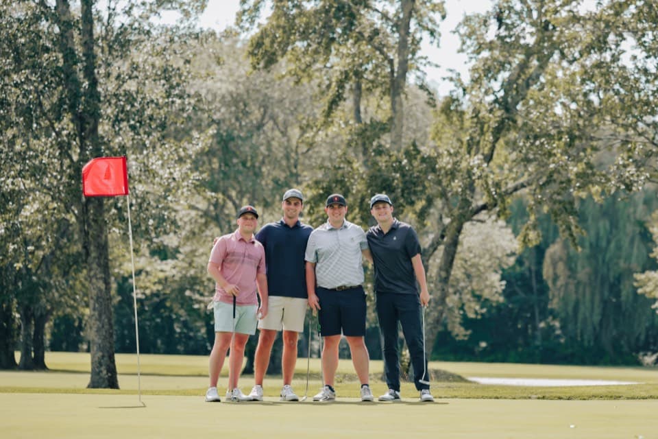 Foursome posing on the green